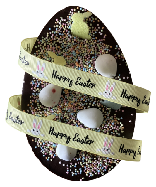 Decorative Easter egg with 'Happy Easter' ribbon and small eggs inside