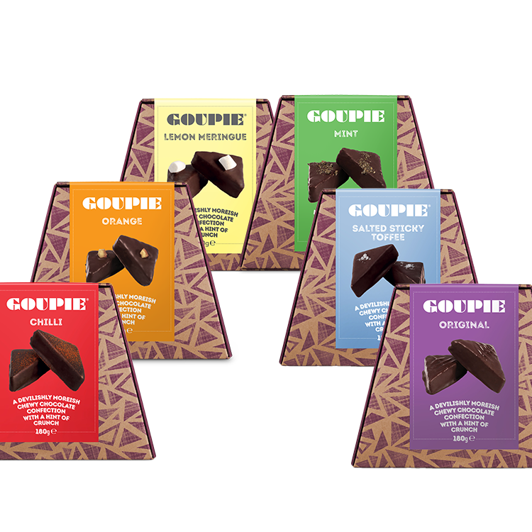 Set of vegan chocolate boxes in various flavours with colourful packaging arranged in a rainbow