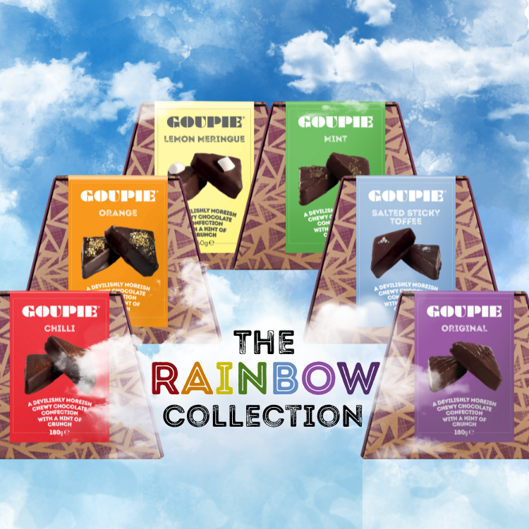 Set of vegan chocolate boxes in various flavours with colourful packaging arranged in a rainbow