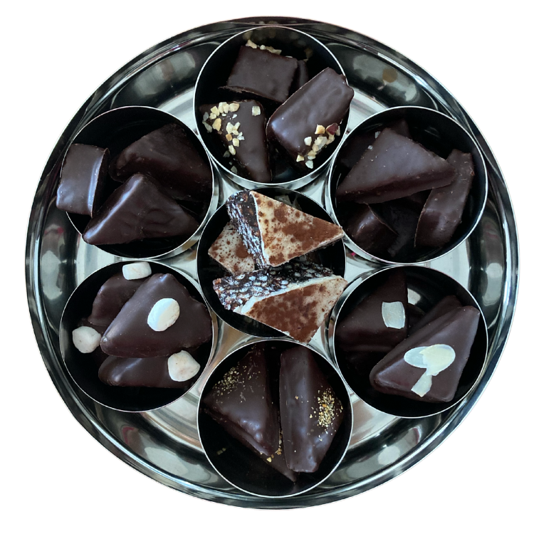 an internal view of a filled tin showing each of the 7 flavours contained in each of their separate mini tins