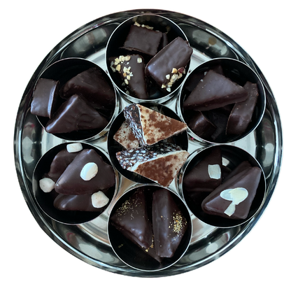 an internal view of a filled tin showing each of the 7 flavours contained in each of their separate mini tins