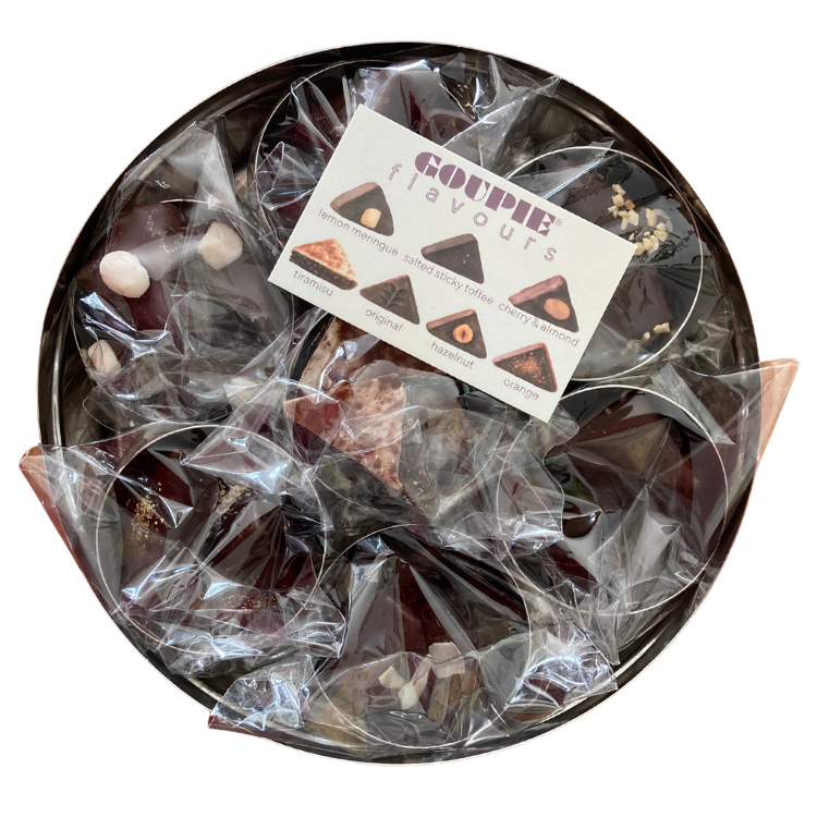 an internal view of the tin showing how the chocolate comes wrapped. Each tin is filled with its respective flavour and wrapped in its own separate home compostable bag. a flavour card is also included