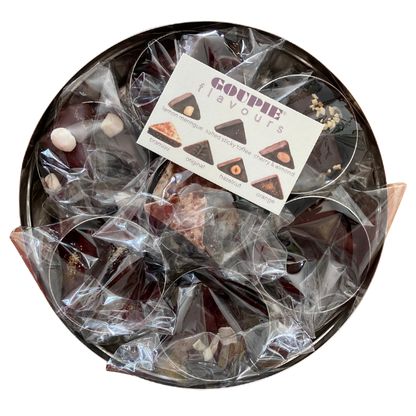 an internal view of the tin showing how the chocolate comes wrapped. Each tin is filled with its respective flavour and wrapped in its own separate home compostable bag. a flavour card is also included